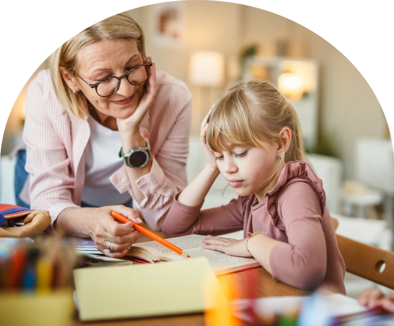Educator guiding child at desk